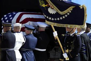 President Reagan's flag-covered casket being loaded on to a plane for transport